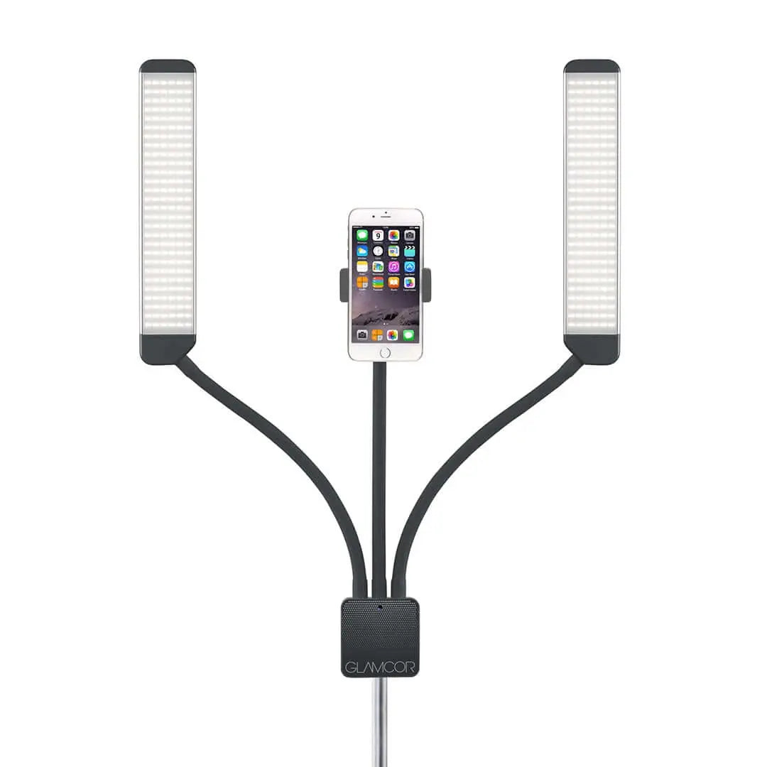 The Glamcor Universal Phone Clip in black mounted on the Multimedia X light kit with a phone securely held in place. The phone is displayed in landscape orientation, highlighting the clip's ability to adjust and fit different phone sizes.
