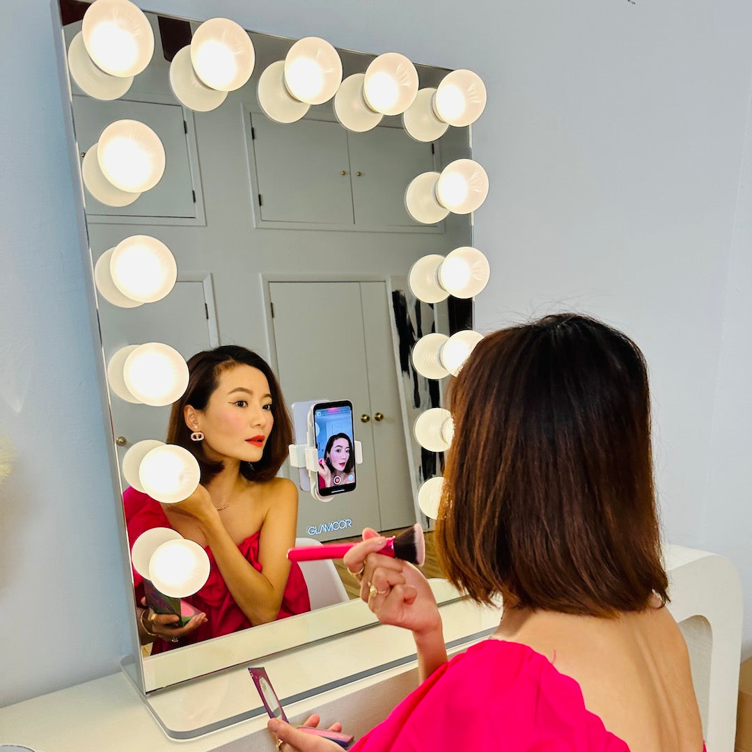 Riki Hollywood Mirror being used for makeup application, highlighting its practicality.